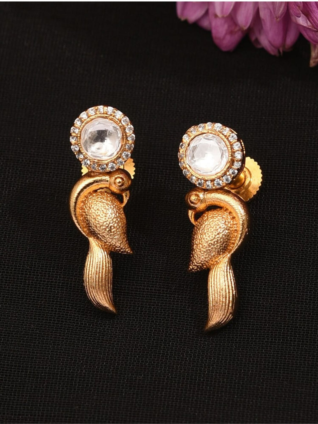 Close-up of Glass Kundan Polki Parrot Studs Earrings worn on a woman's ear showcasing intricate design