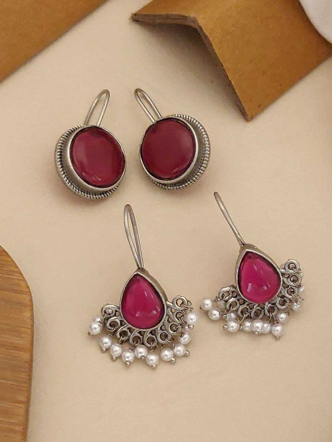 German Silver Set Of 2 Earring Combo featuring round and drop designs with pink stones and pearl accents