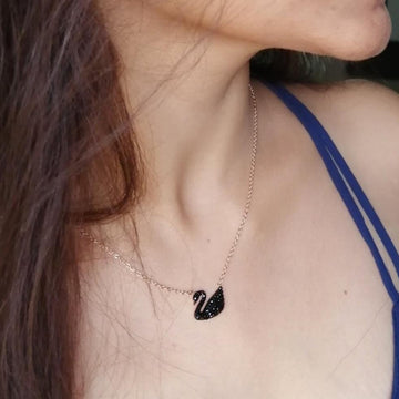 Elegant black swan necklace featuring a delicate design, ideal for stylish outfits