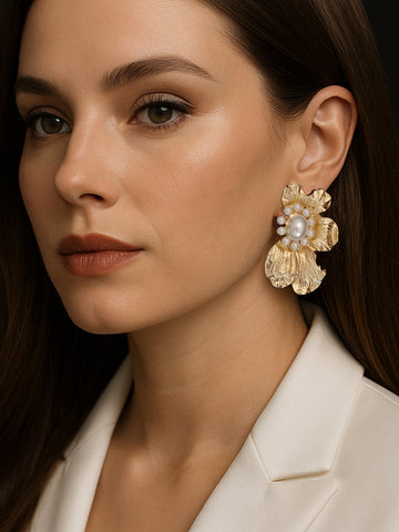 Close-up of a woman wearing large gold floral earrings with pearls from the Under ₹499 collection
