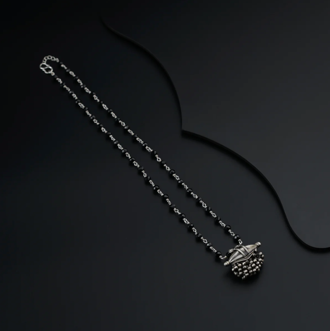Elegant 925 Sterling Silver Jewellery Mangalsutra necklace with intricate pendant on black background