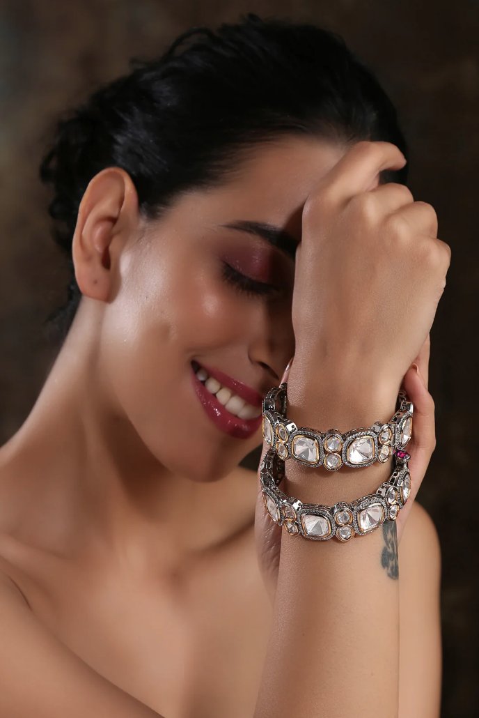 Elegant woman showcasing stunning gemstone bangles, highlighting style and cultural significance in jewelry fashion