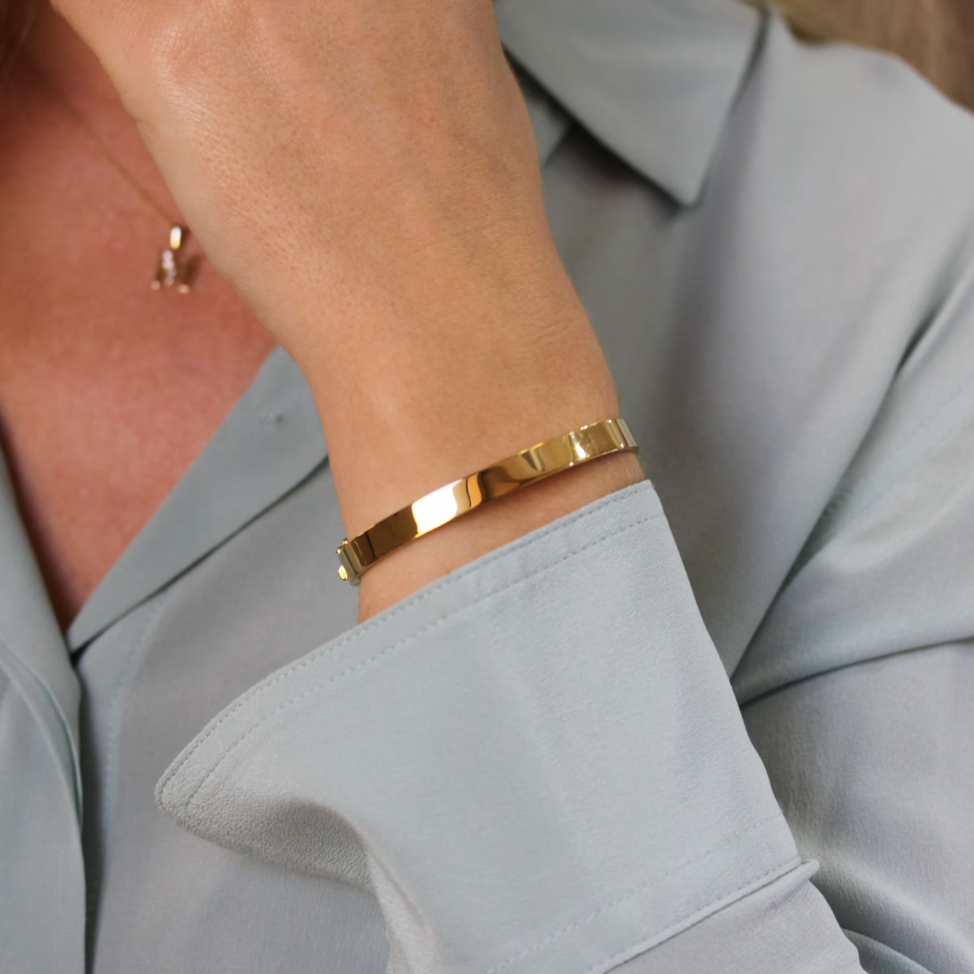 Elegant gold bangle bracelet worn on wrist showcasing stylish women bracelets collection