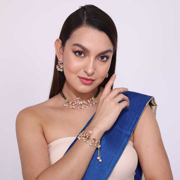 Bridal Mangalsutra set with matching earrings, bracelet, and floral design necklace worn by model