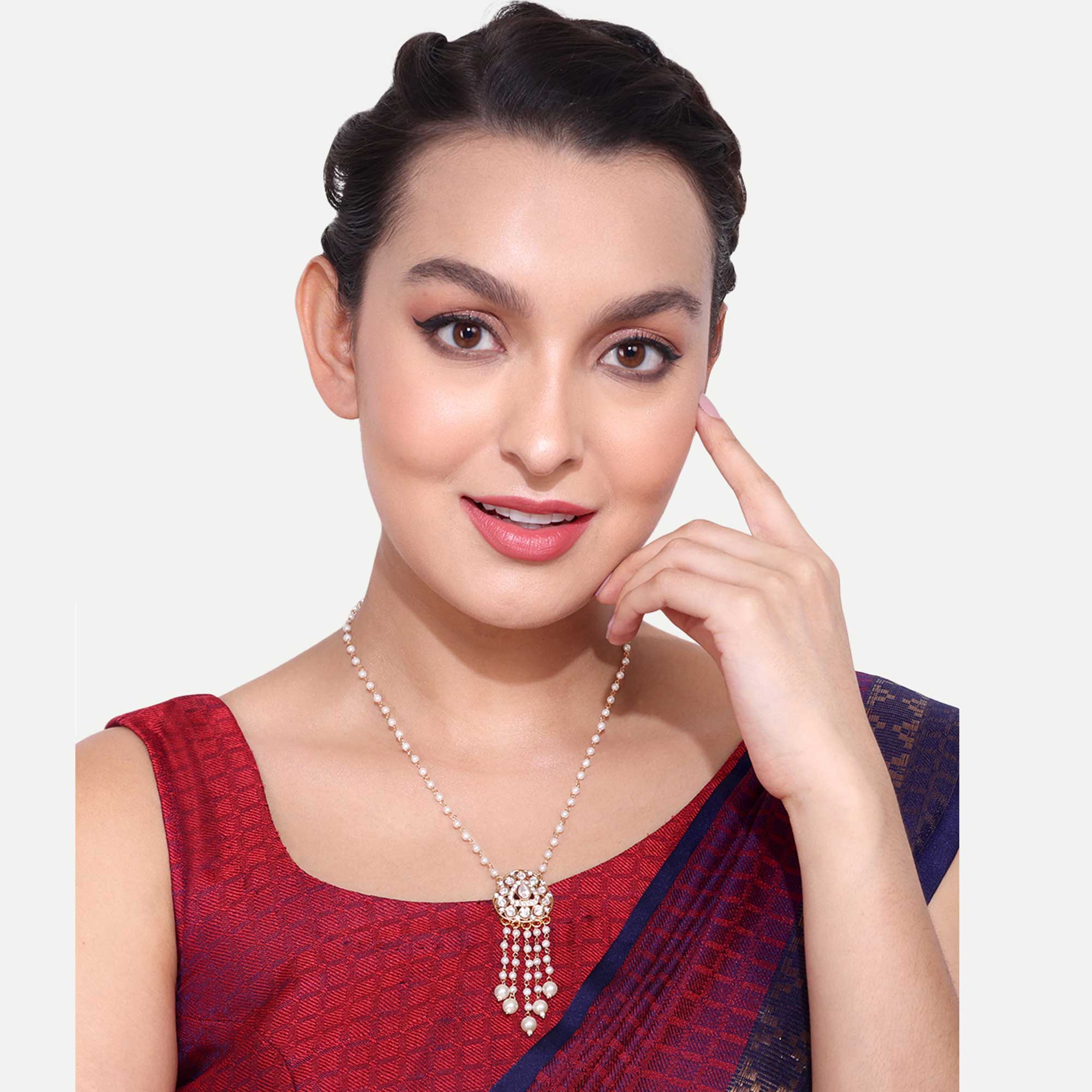 Woman wearing elegant pearl premium pendent chains with intricate pendant design and traditional attire