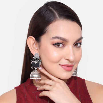 Close-up of woman wearing stylish oxidise earring with intricate design and jhumka style