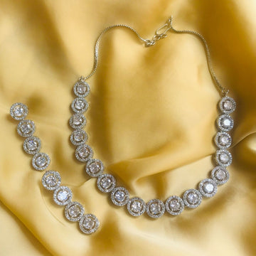 Elegant American Diamondcz Zircon Necklace and matching earrings set displayed on golden fabric
