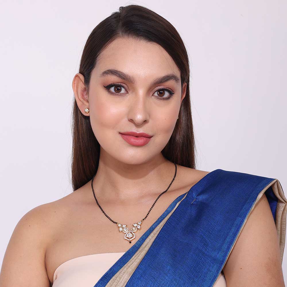 Elegant Pachi Kundan Mangalsutra necklace worn by woman in blue saree with matching earrings