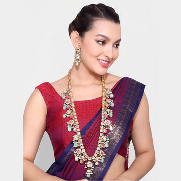 Woman wearing traditional red and blue saree with an elaborate Bead Mala necklace and matching earrings