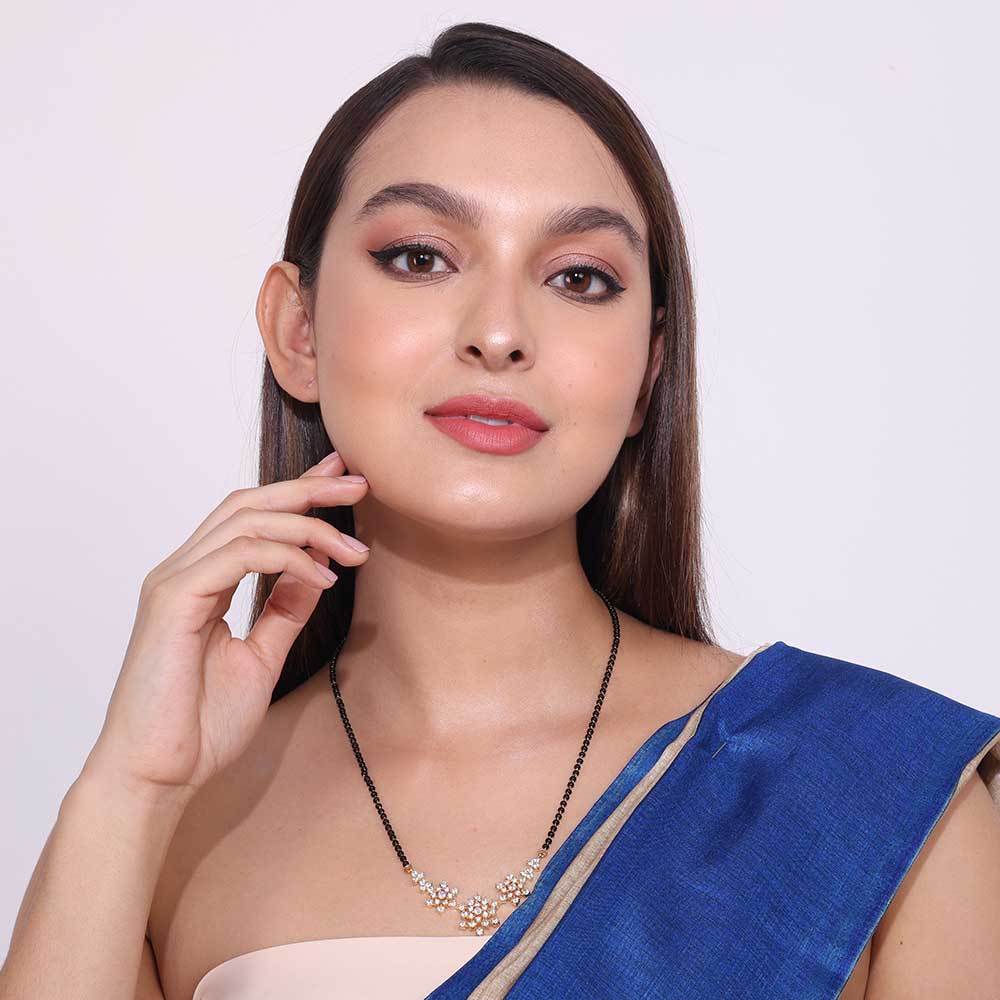 Elegant Dailywear Mangalsutra with floral pendant worn by woman in blue saree for everyday use