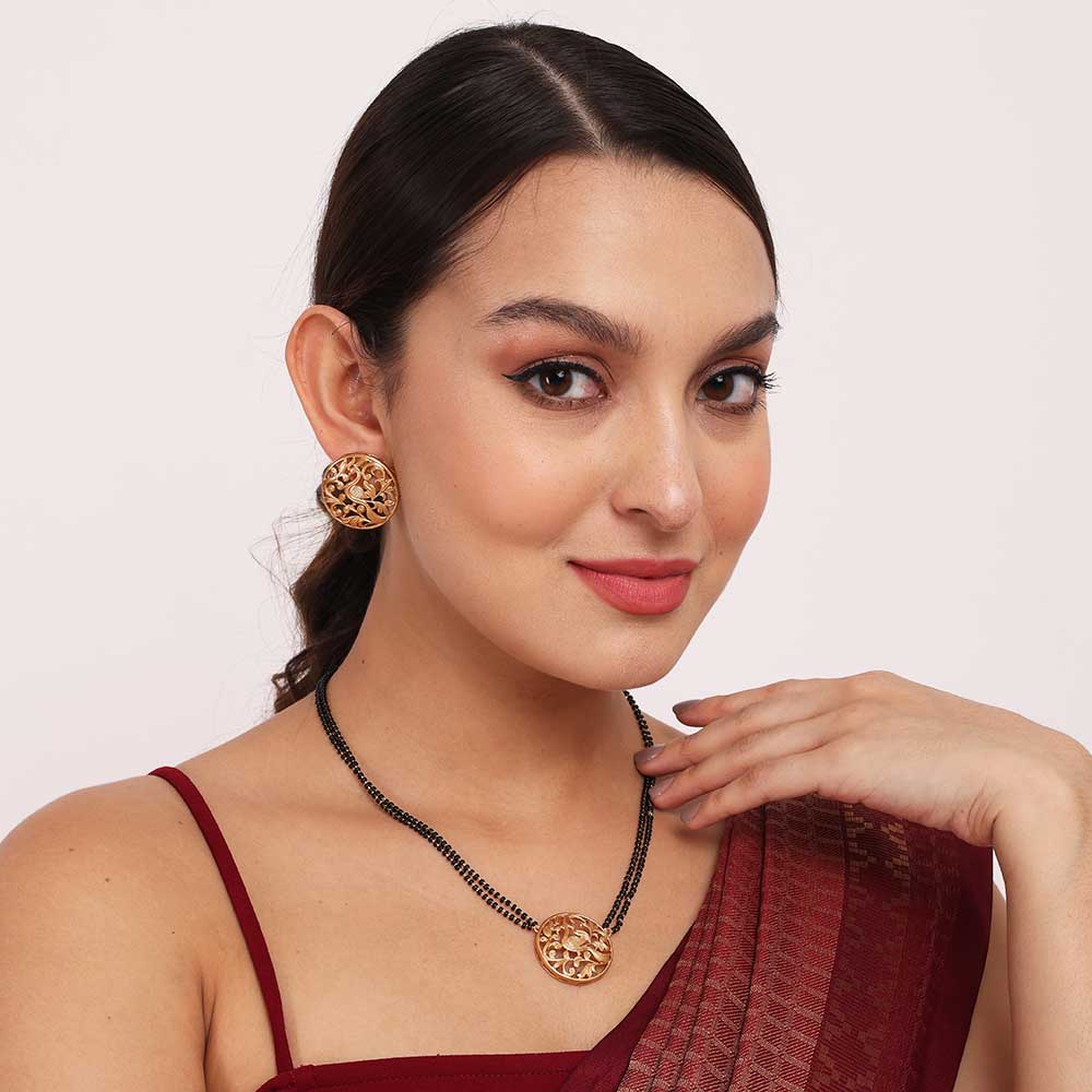 Elegant woman wearing an Antique Mangalsutra necklace with matching earrings in traditional attire
