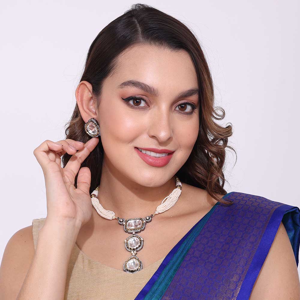 Elegant woman wearing party necklaces with silver beads and white thread paired with matching earrings