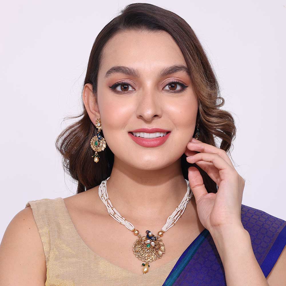 Woman wearing traditional Meenakari Necklaces with intricate designs and colorful stones