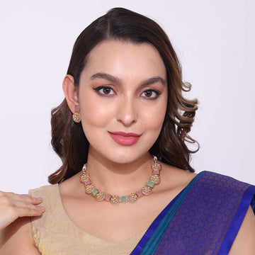 Woman wearing elegant Kempstone Necklaces and matching earrings with traditional attire