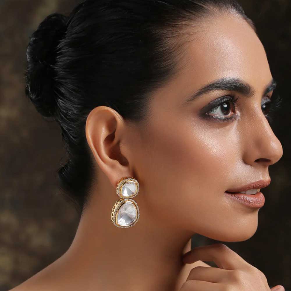 Close-up of woman wearing elegant Polki Earrings with uncut diamonds and gold detailing