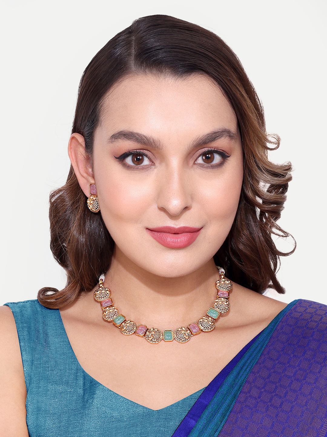 Woman wearing a colorful Antique Gold Necklace with intricate designs and matching earrings