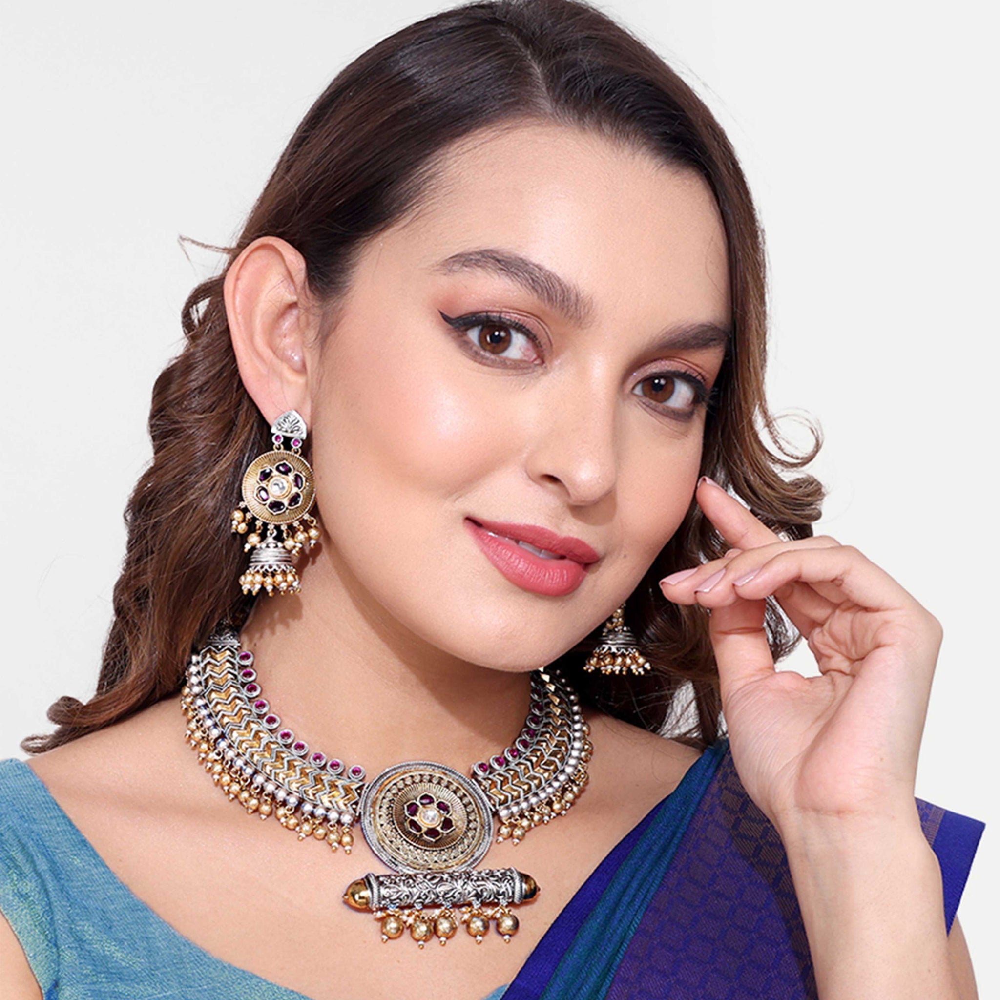 Woman wearing elegant Two Tone Jewellery necklace and matching earrings with intricate design