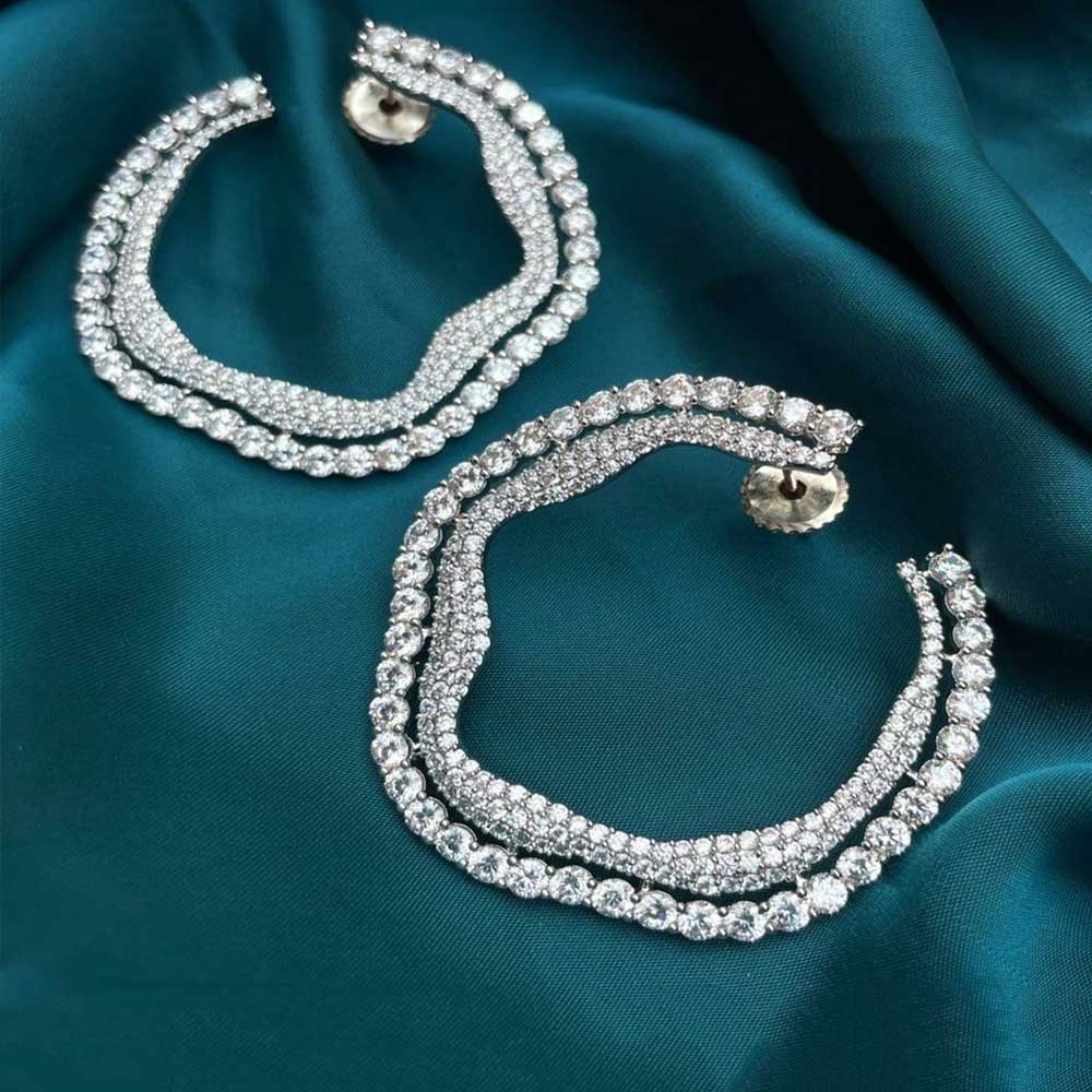 Elegant Balis/Hoops Earrings encrusted with sparkling crystals on teal fabric background