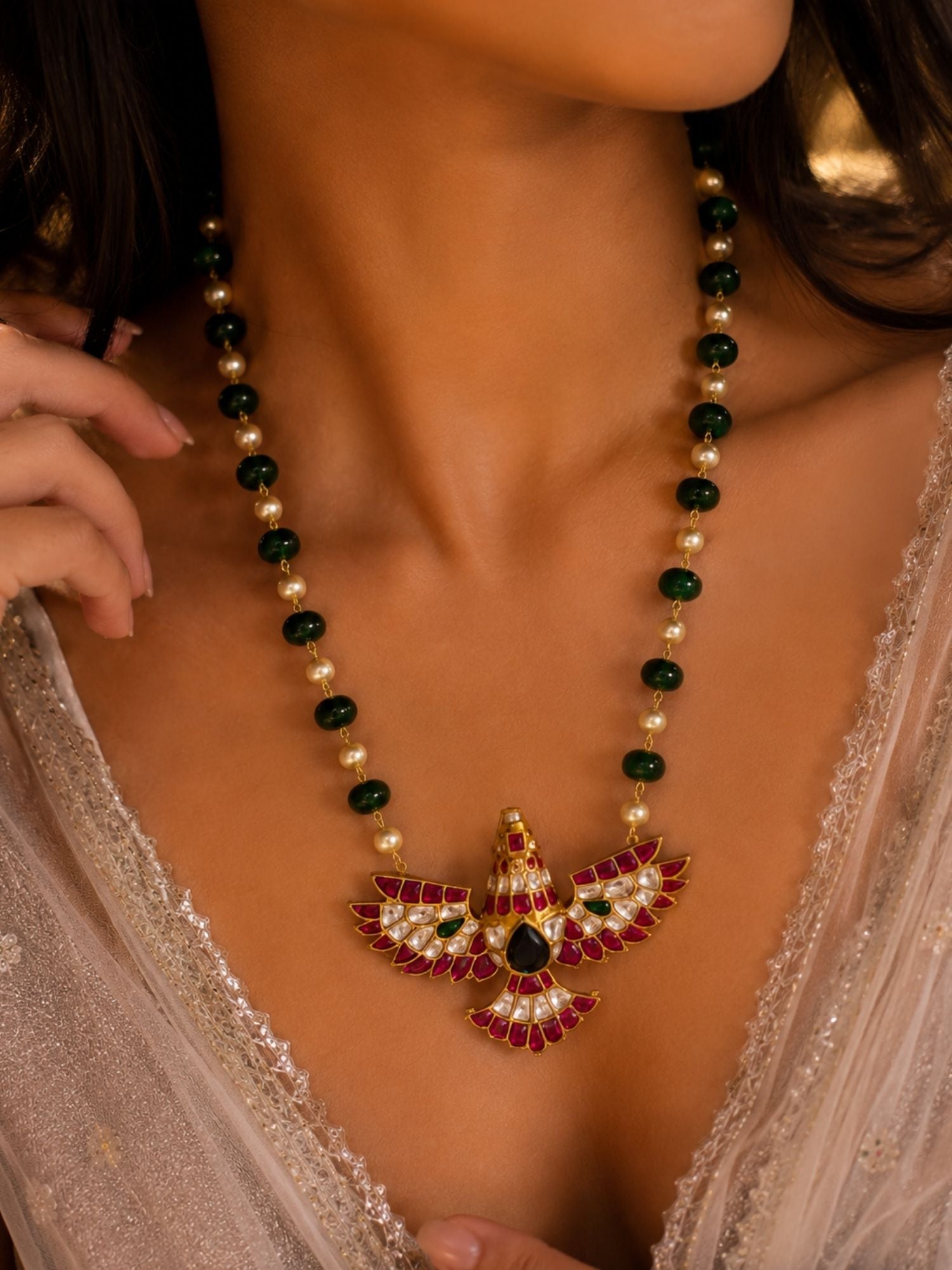 Model wearing green beaded Kundan necklace, close-up of bird pendant on neckline