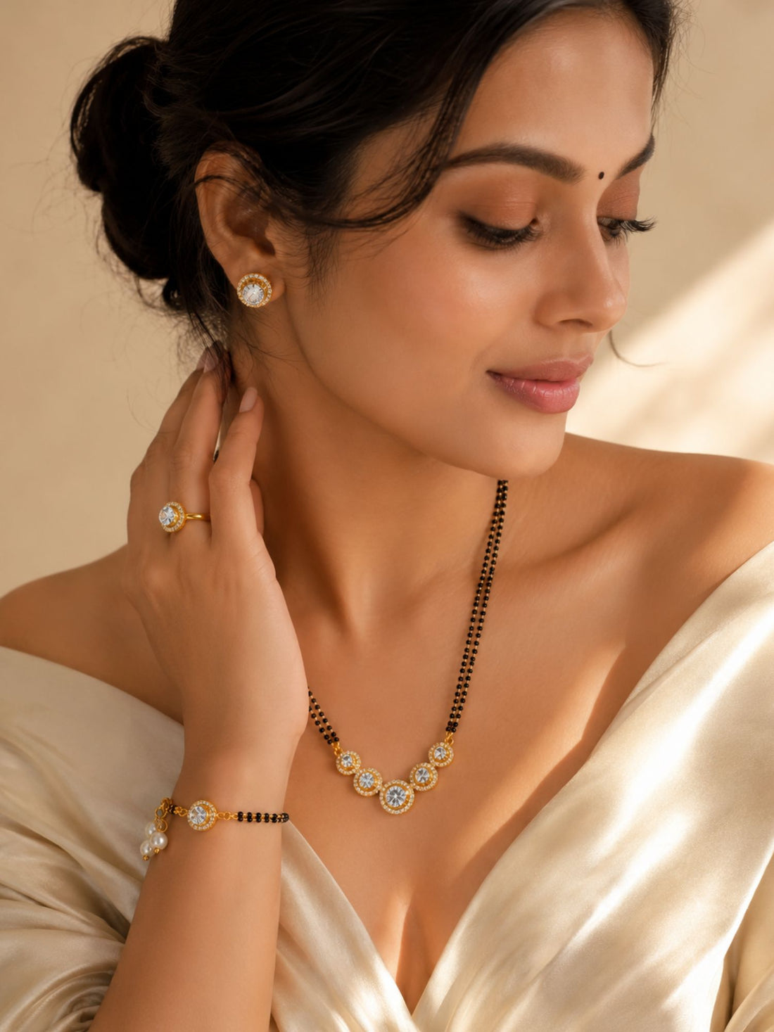 Woman wearing gold plated American Diamond mangalsutra combo with matching earrings, bracelet and ring