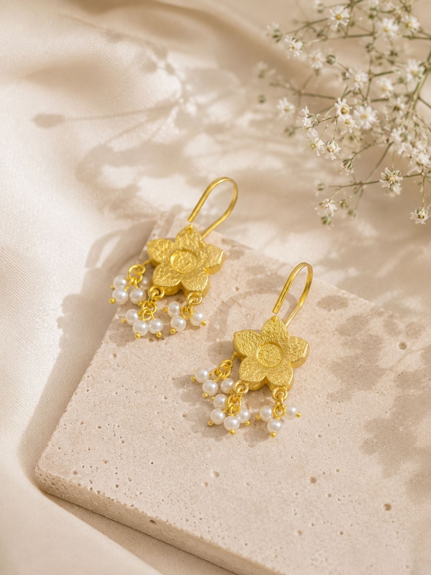 Close-up of pink Kundan-style stones and floral motifs on layered chain necklace