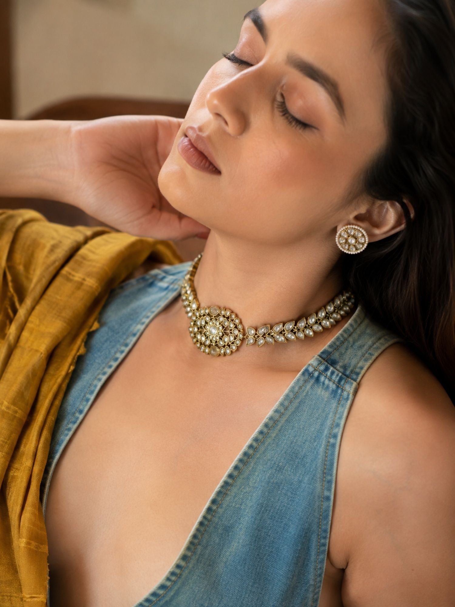 Close-up of floral Kundan-style stones on antique gold choker