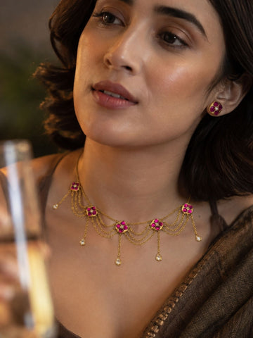 Gold plated pink Kundan floral layered chain necklace set on model with matching stud earrings