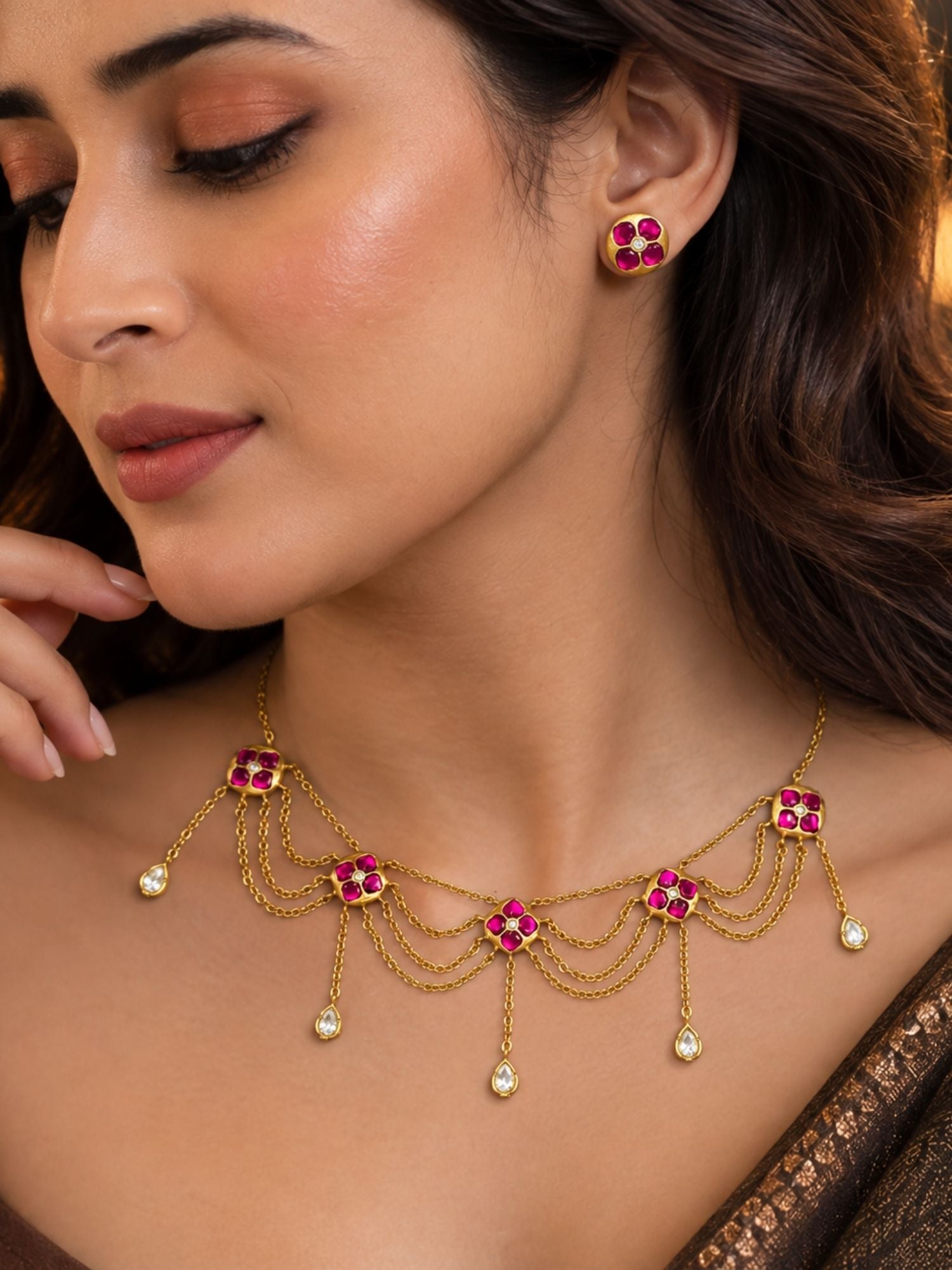Close-up of gold plated pink Kundan layered chain necklace with teardrop crystals on model neckline