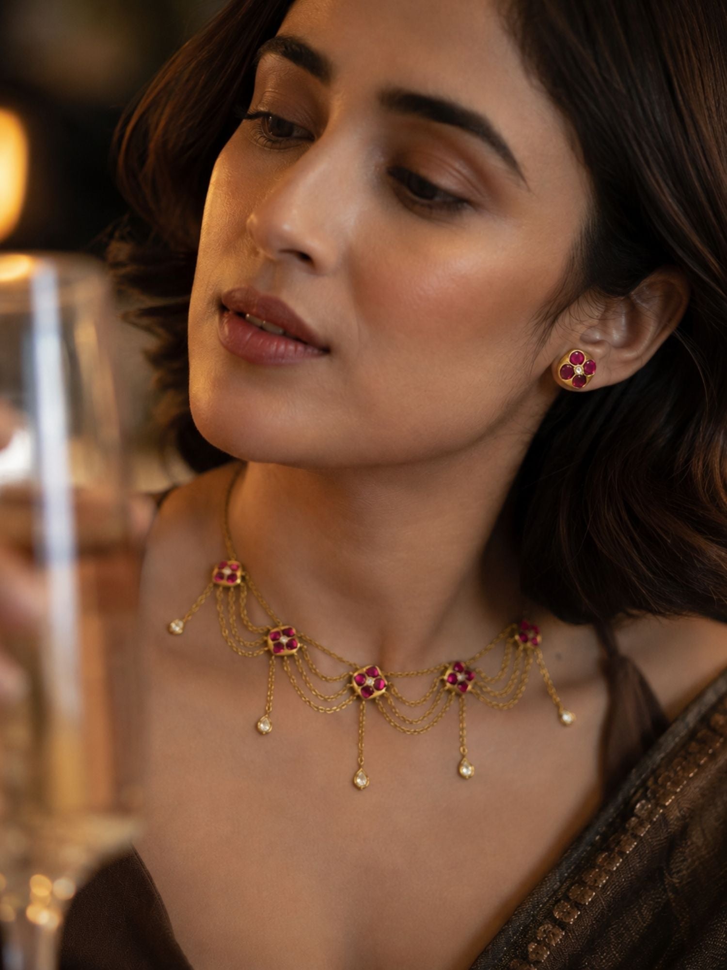 Model close-up showing pink Kundan floral layered chain necklace and matching stud earring, side profile