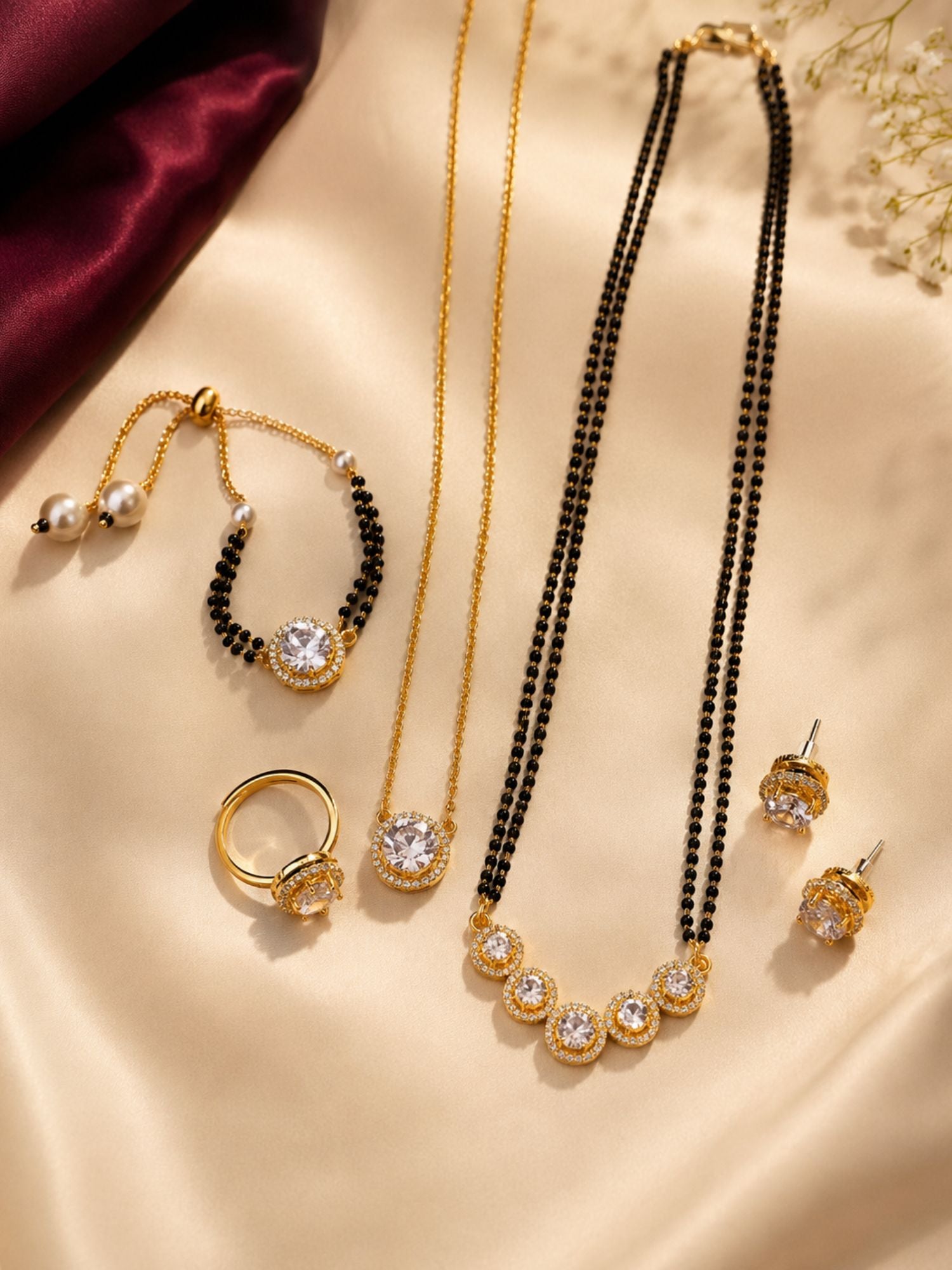 5 piece gold plated American Diamond mangalsutra combo with long and short mangalsutra, earrings, bracelet and ring