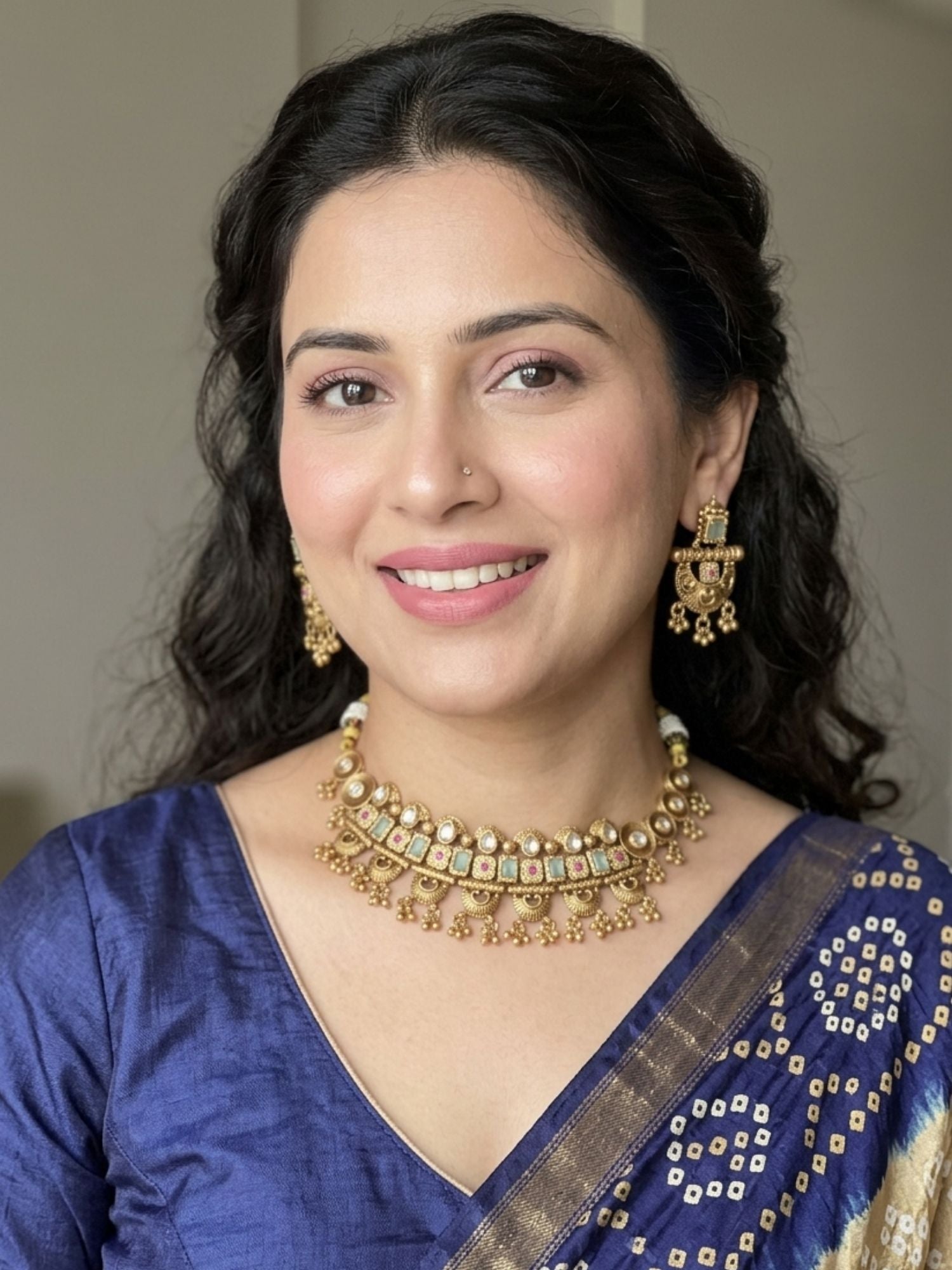Woman wearing Abdesigns gold mini choker necklace set styled with elegant traditional and minimal ethnic outfit