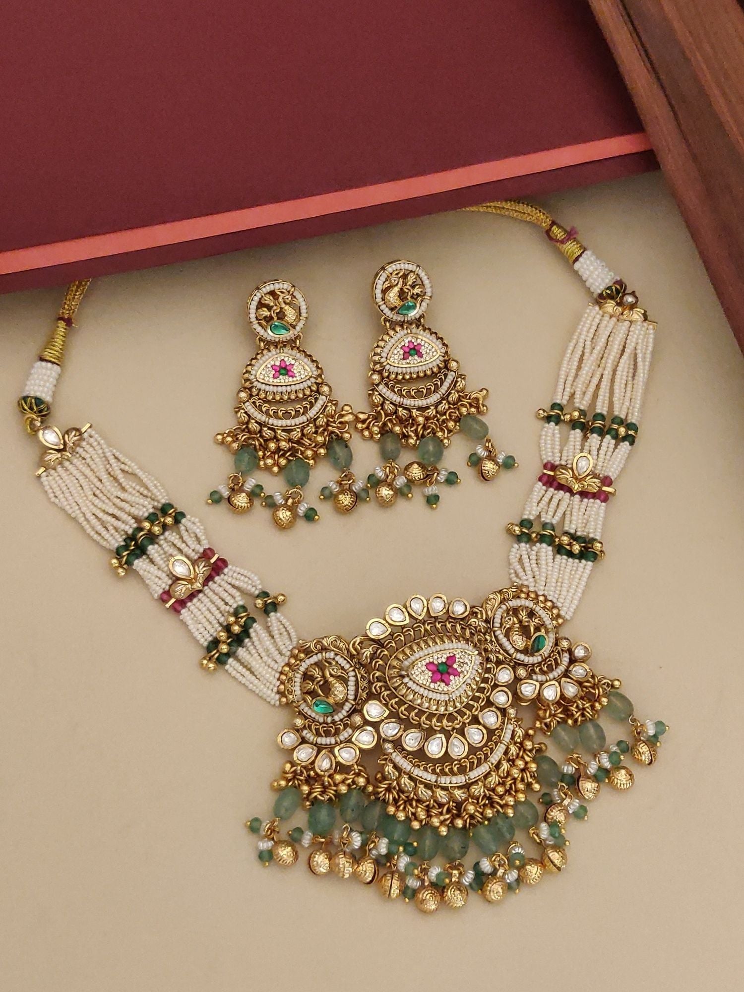 gold plated Ahmedabadi choker necklace set with multi strand pearls green bead drops and matching jhumka earrings
