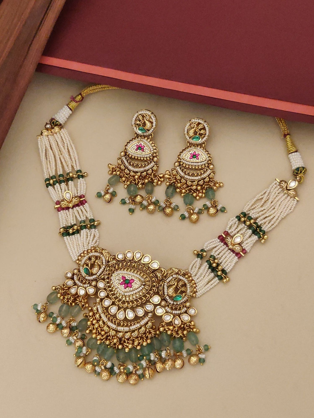 gold plated Ahmedabadi choker necklace set with multi strand pearls green bead drops and matching jhumka earrings