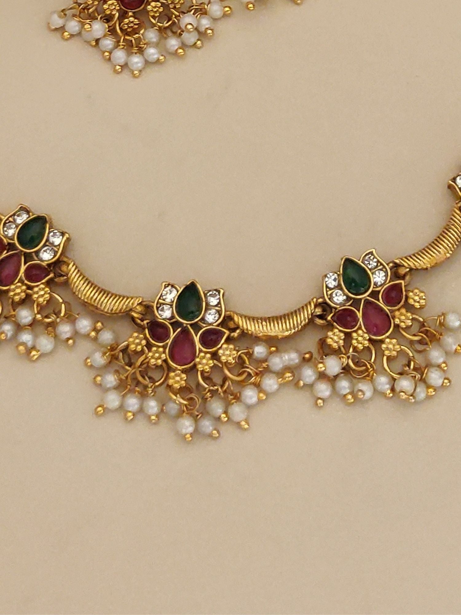 Gold Plated Kempstone Lotus Beads Necklace Set featuring gold lotus motifs with red and green kemp stones and pearl tassels
