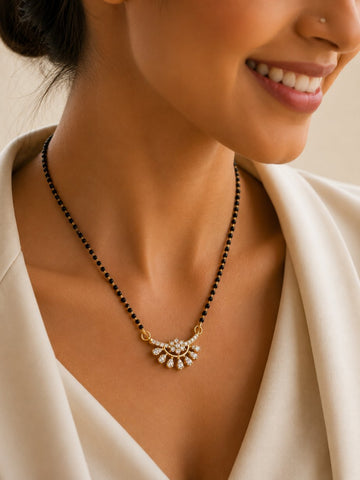 Close-up of gold plated brass mangalsutra pendant with CZ stone detailing on model