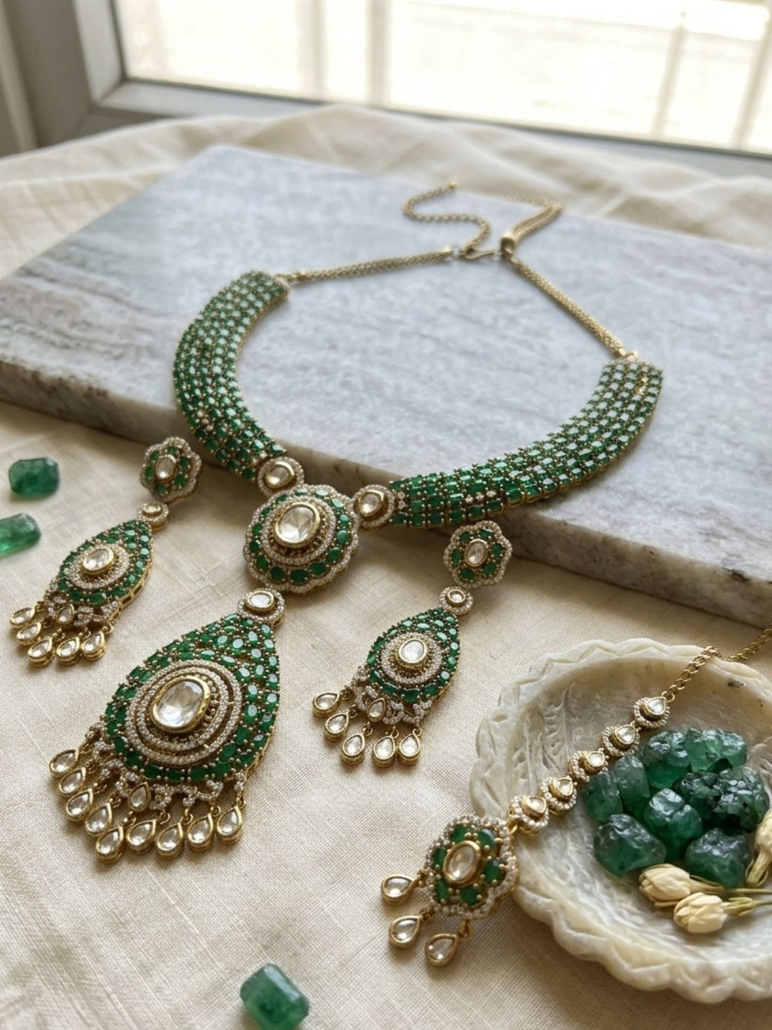 Woman wearing Abdesigns emerald green polki Victorian style necklace set styled with luxurious traditional Indian outfit