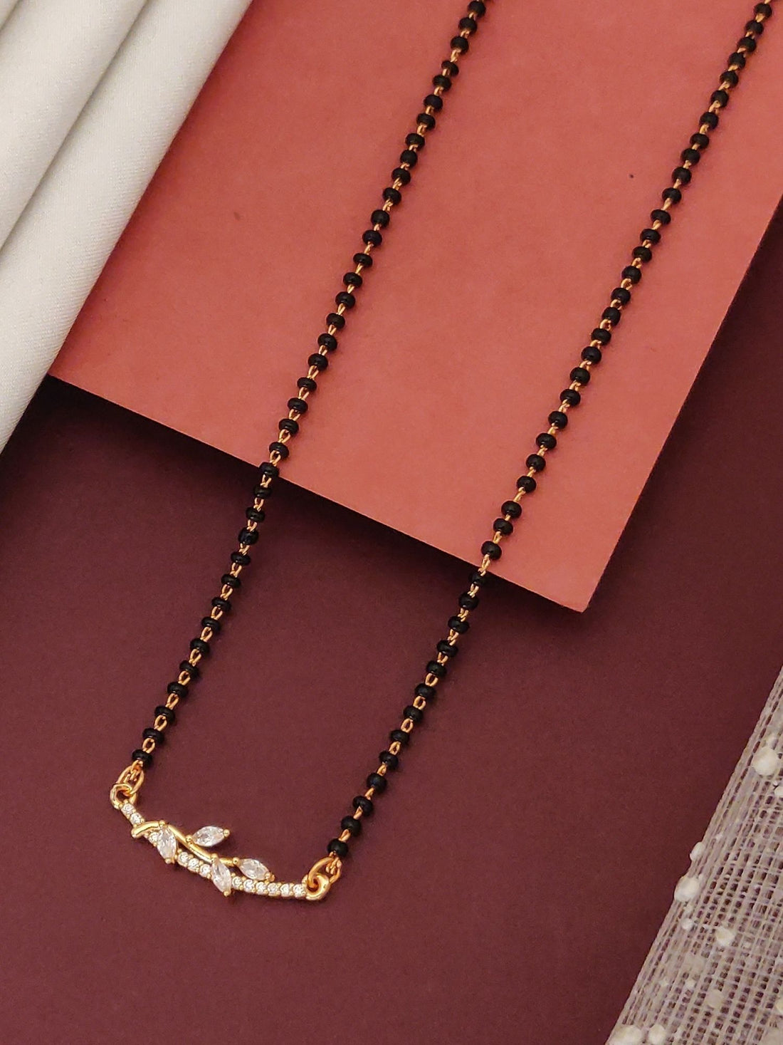 Abdesignsjewellery flower design mangalsutra necklace with black beads and gold floral pendant with white stones