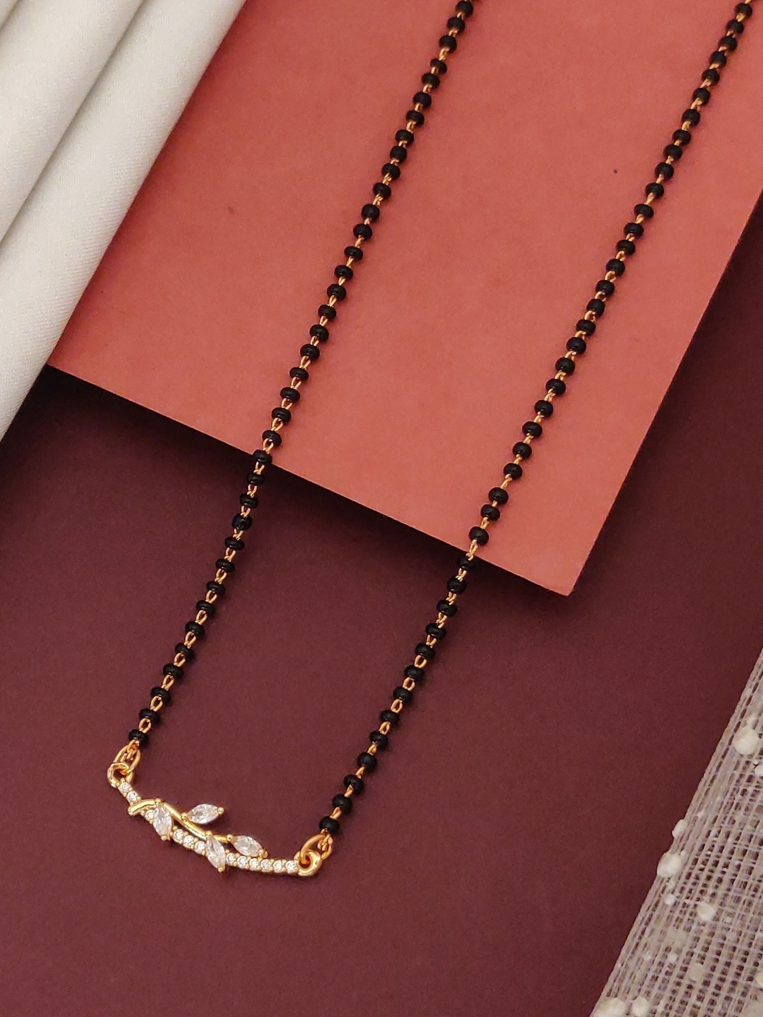 Abdesignsjewellery flower design mangalsutra necklace with gold chain black beads and crystal leaf pendant for traditional wear