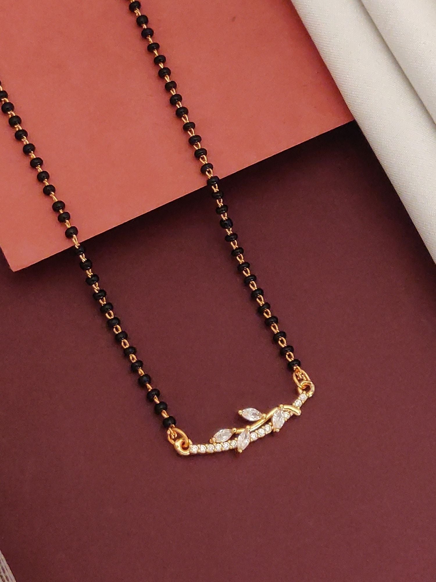 Abdesignsjewellery flower design mangalsutra necklace with black beads and gold floral cubic zirconia pendant