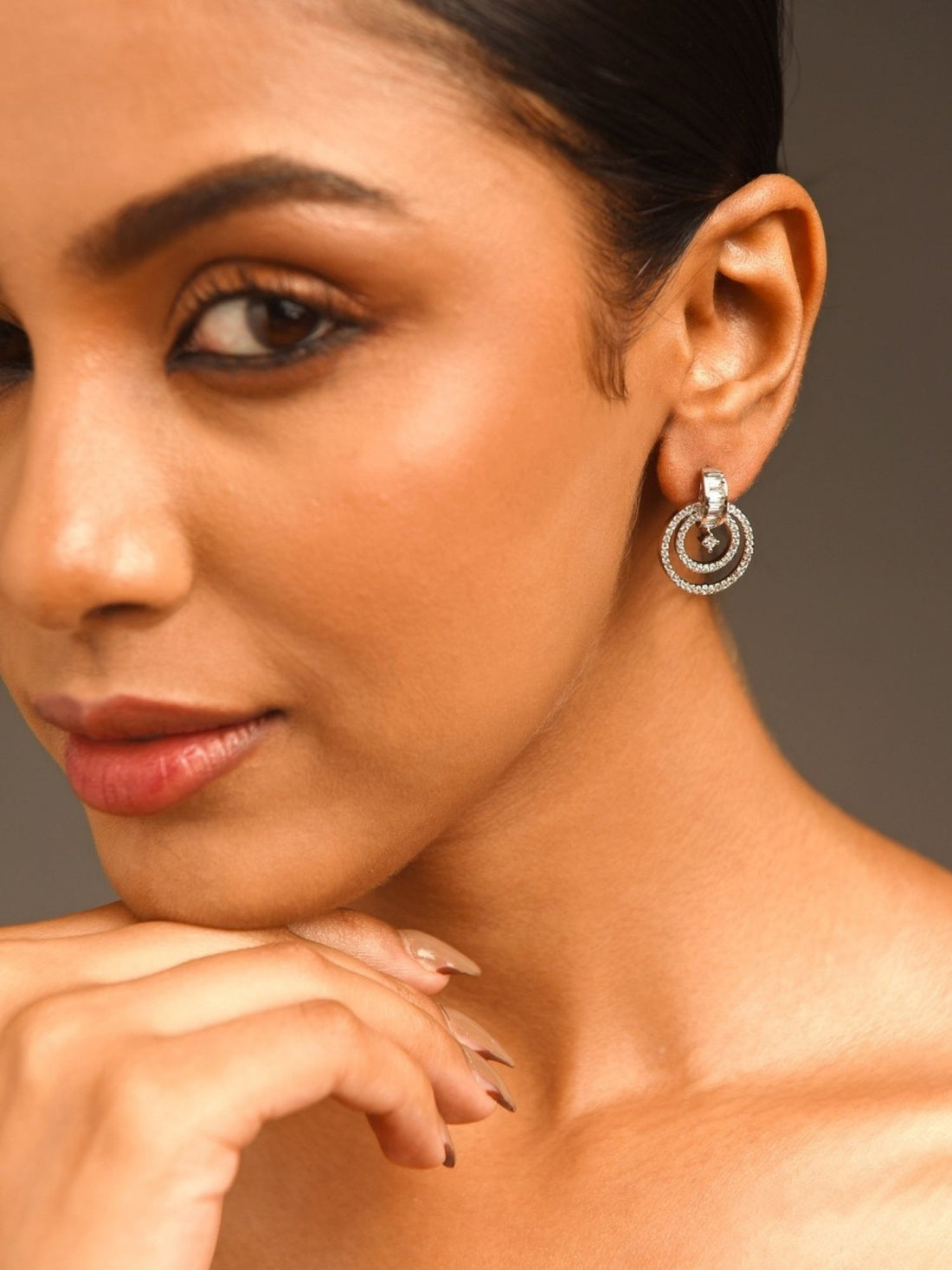 Stunning Silver Plated American Diamond Earring worn by a woman with elegant makeup