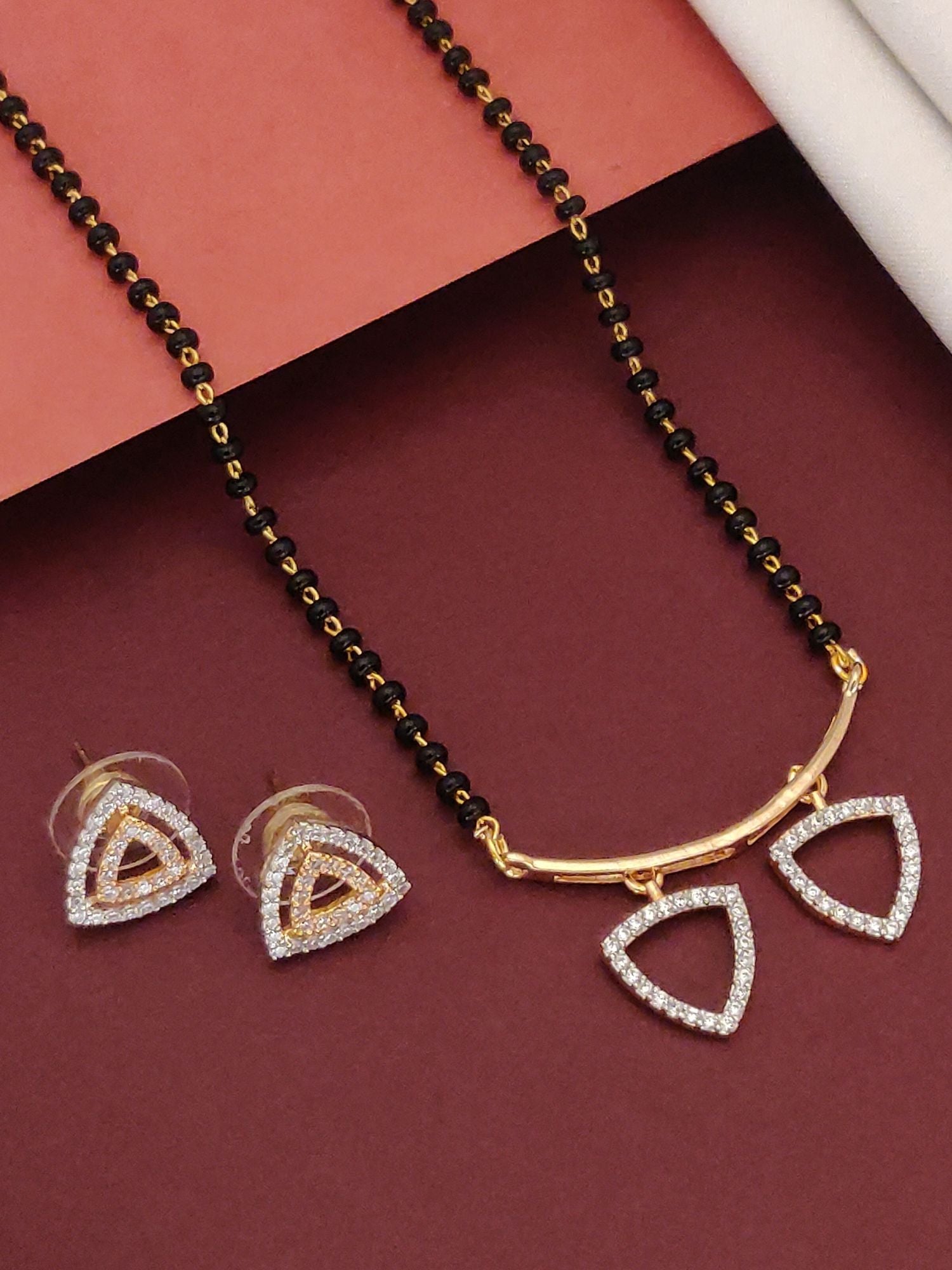 Abdesigns Gold CZ Mangalsutra Set with Earrings.. black bead mangalsutra with twin triangular CZ pendants and matching earrings