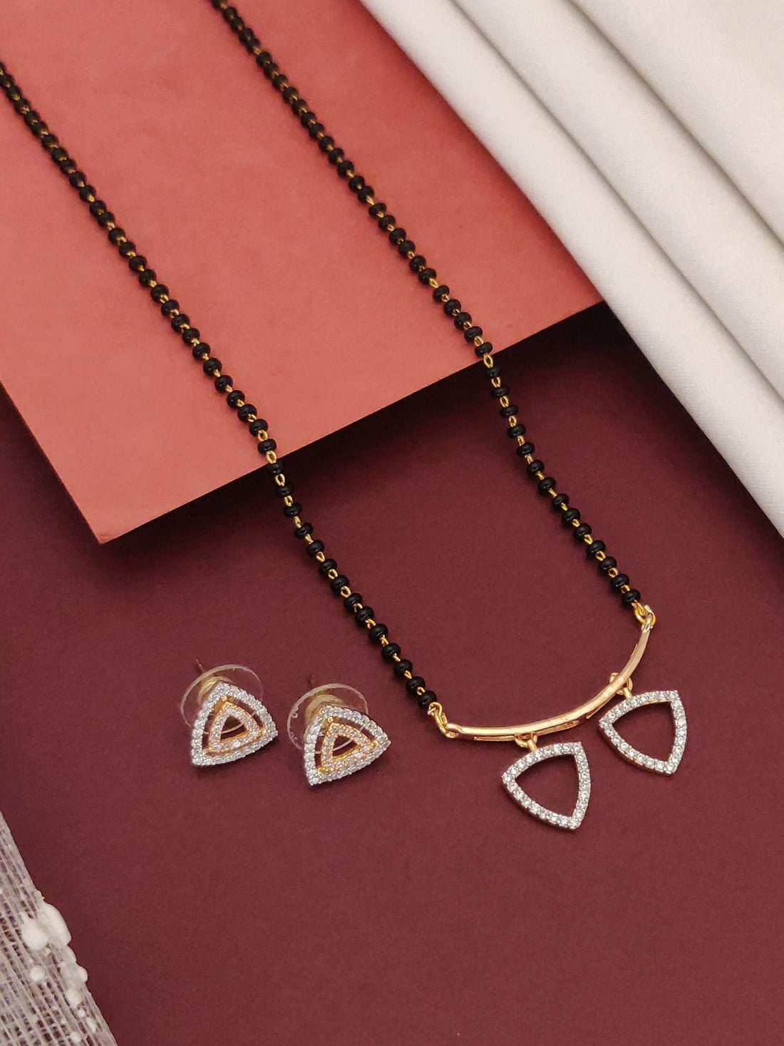 Abdesigns Gold CZ Mangalsutra Set with Earrings.. Black bead mangalsutra gold bar with triangular CZ pendants and matching studs