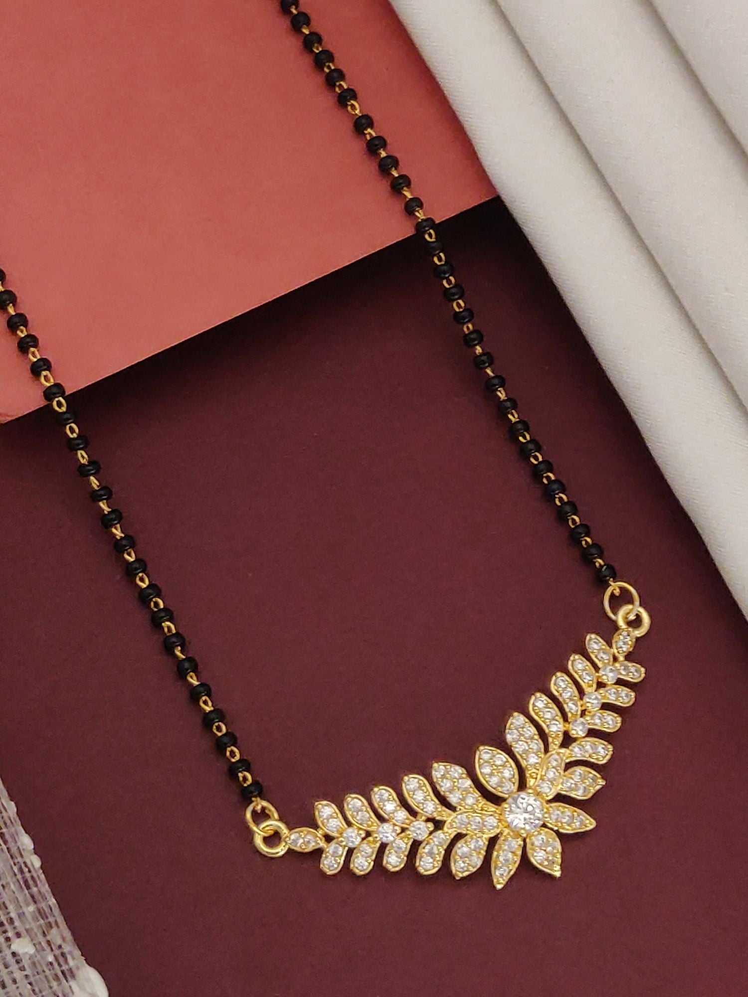 Abdesigns Gold Leaf CZ Mangalsutra gold plated leaf pendant with cubic zirconia and black bead chain