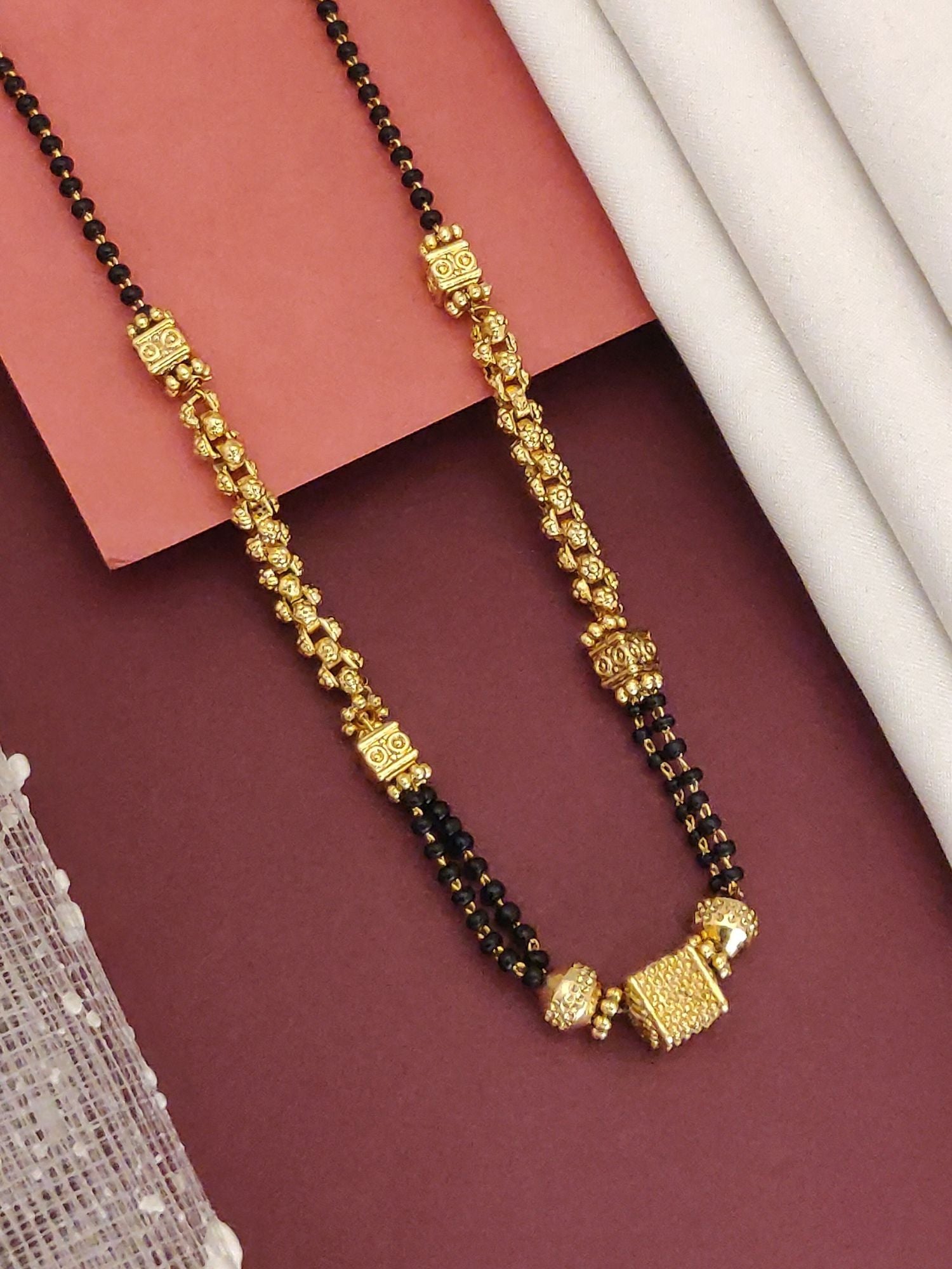 Abdesigns Gold-Plated Black Beads Mangalsutra with intricate gold motifs and double black bead chain for traditional weddings