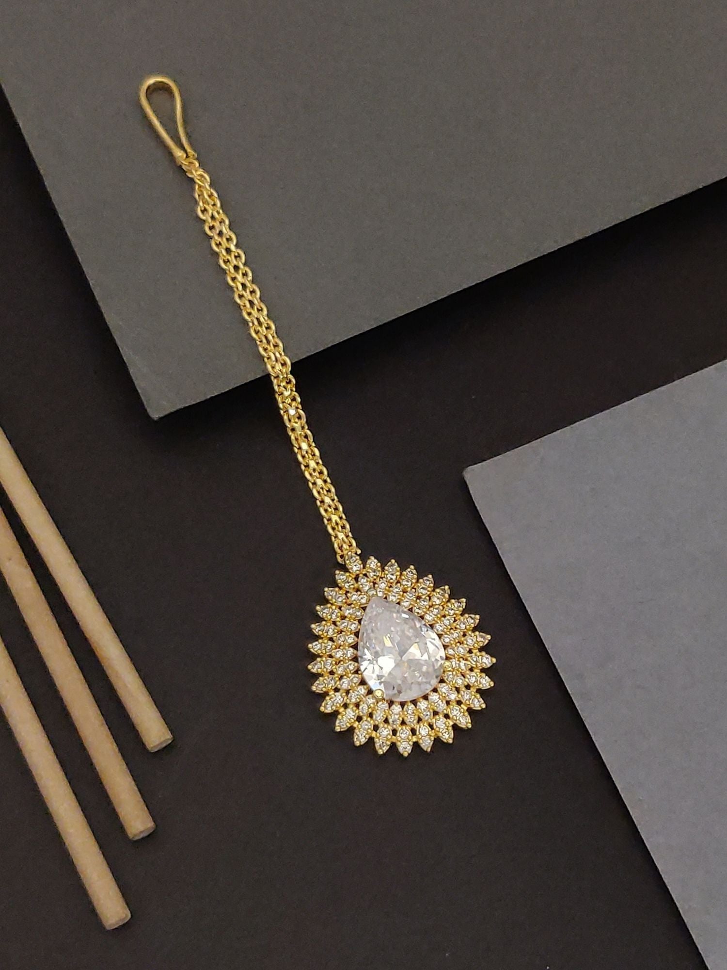 Abdesigns Gold Teardrop CZ Maangtikka. Bridal. Gold chain maangtikka with teardrop cubic zirconia halo on dark backdrop