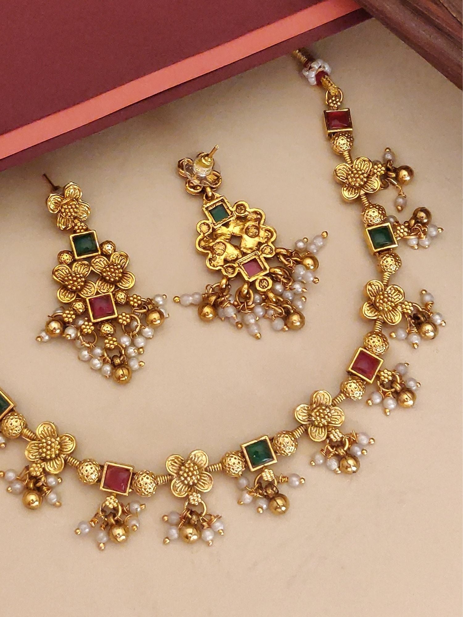 Abdesigns Jewellery Elegant Pendents Chain with Floral Design. Gold floral chain with red and green gems pearl drops and earrings