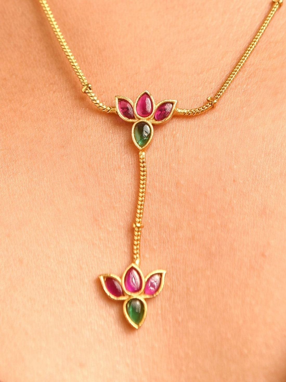 Abdesigns Jewellery Elegant Pendents Chain with Multicolor Stones. Model wearing gold pendant necklace on tan skin