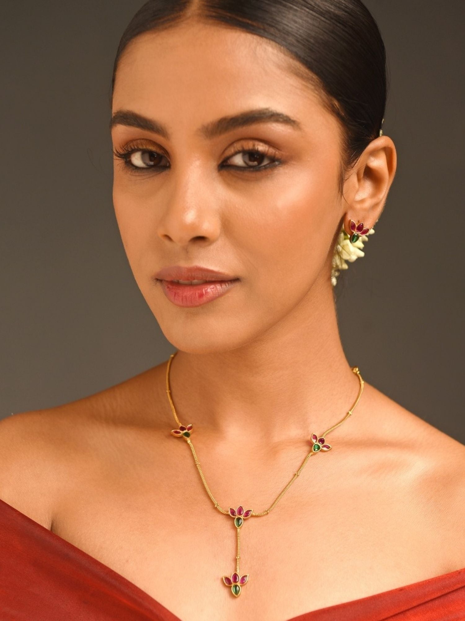 Abdesigns Jewellery Elegant Pendents Chain with Multicolor Stones. Model wearing gold pendant necklace on tan skin