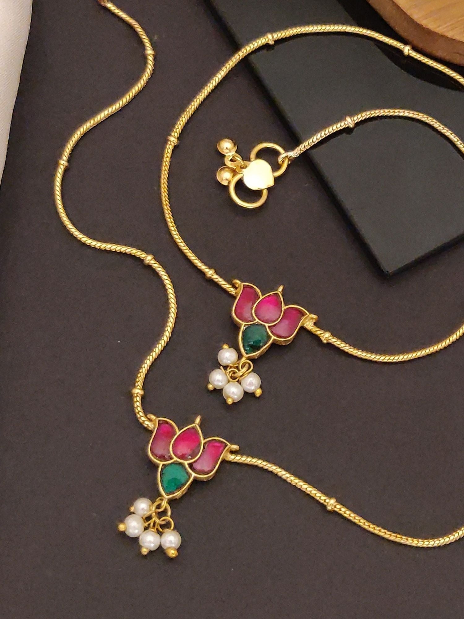 Abdesigns Jewellery Gold Anklets with Lotus Pendants showcasing two gold anklets with pink green enamel and pearl drops