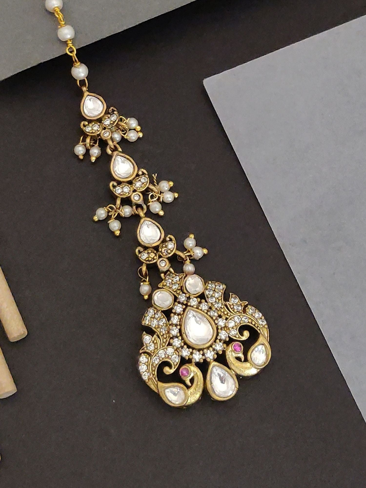 Abdesigns Jewellery Gold-Plated Kundan Pearl Maangtikka.. ornate kundan and pearl design with teardrop stones